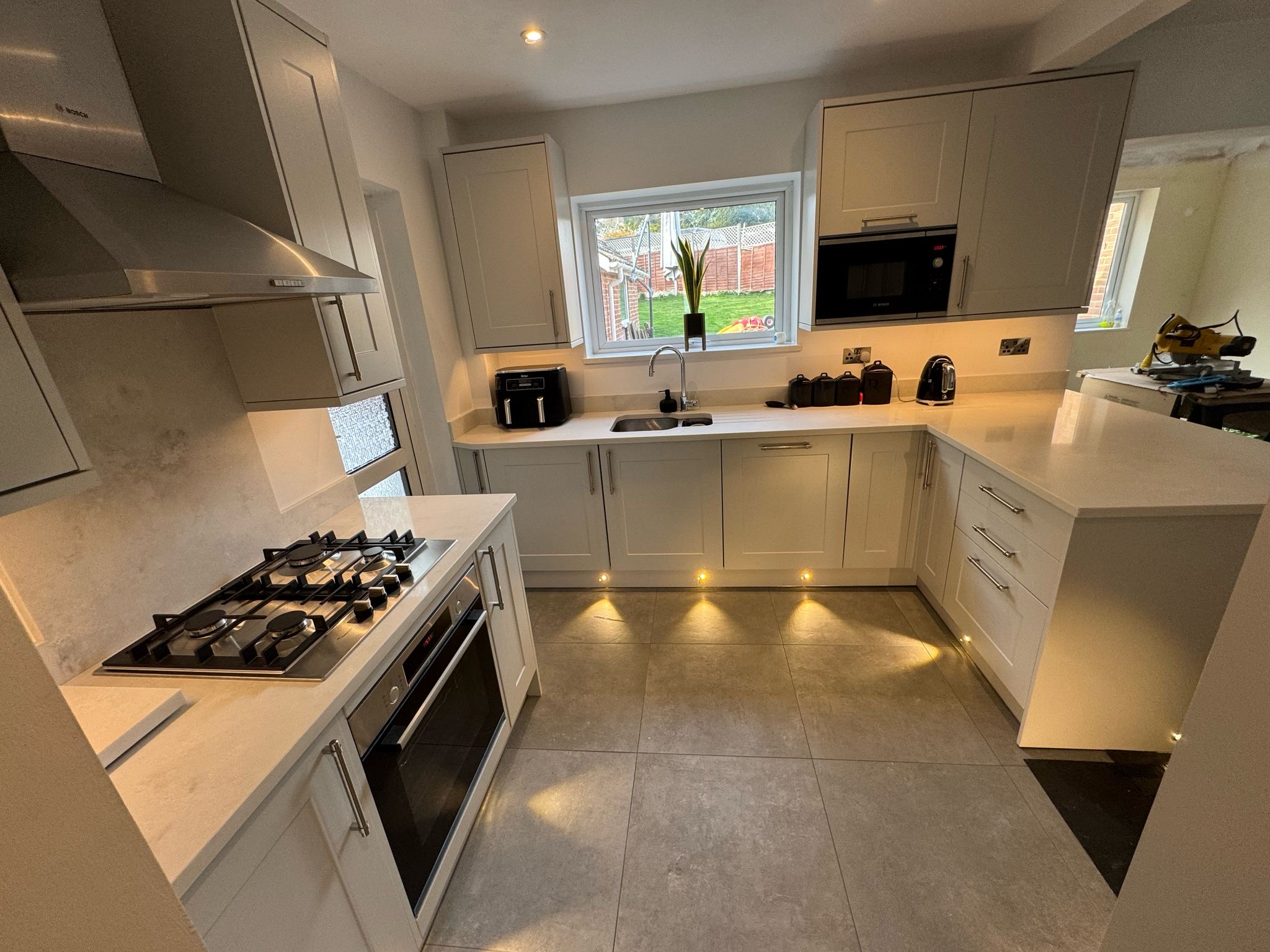 Kitchen with LED downlights, under-cabinet lighting and plinth lights installed in Crawley