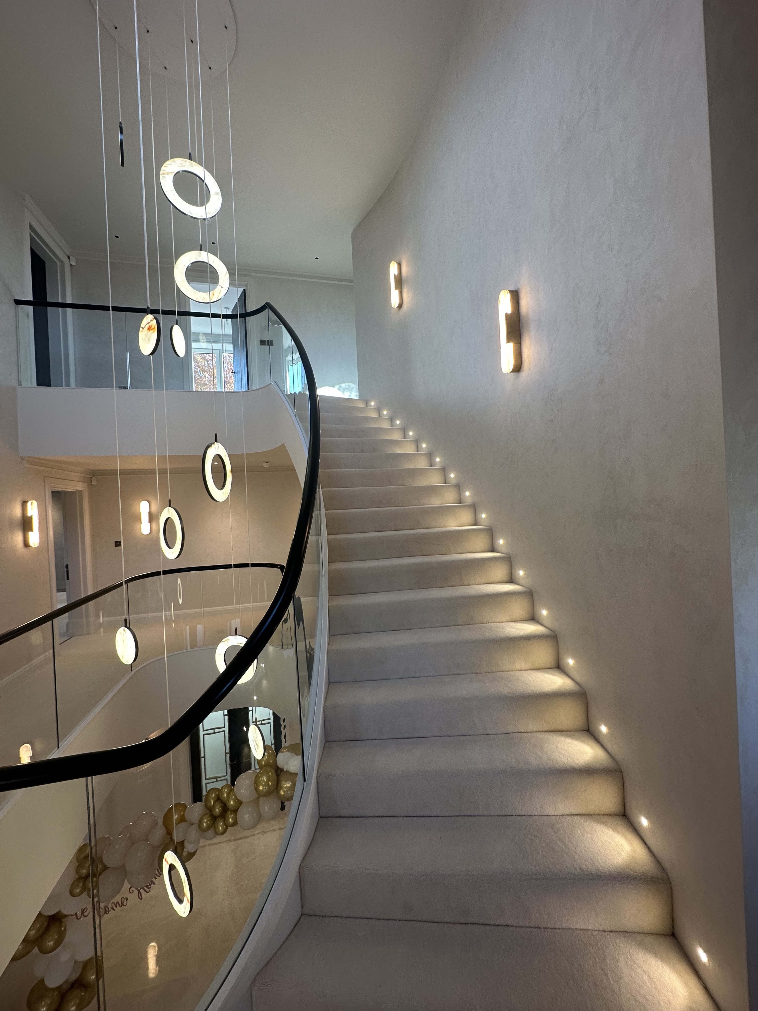 Curved staircase with pendant chandelier and LED stair lights — Lambourn Electrical project